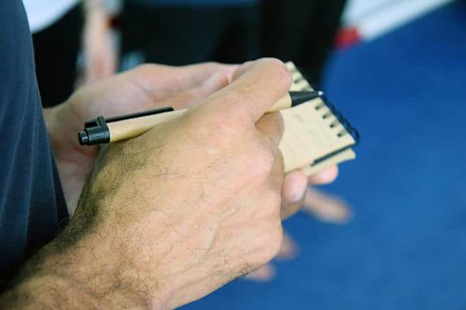 writing in a reporters notebook